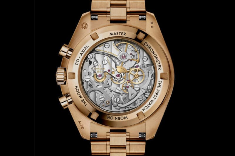 The case back of the 18k Omega Speedmaster Moonwatch Professional New Lacquered Reverse Panda moonshine gold edition watch displaying the movement