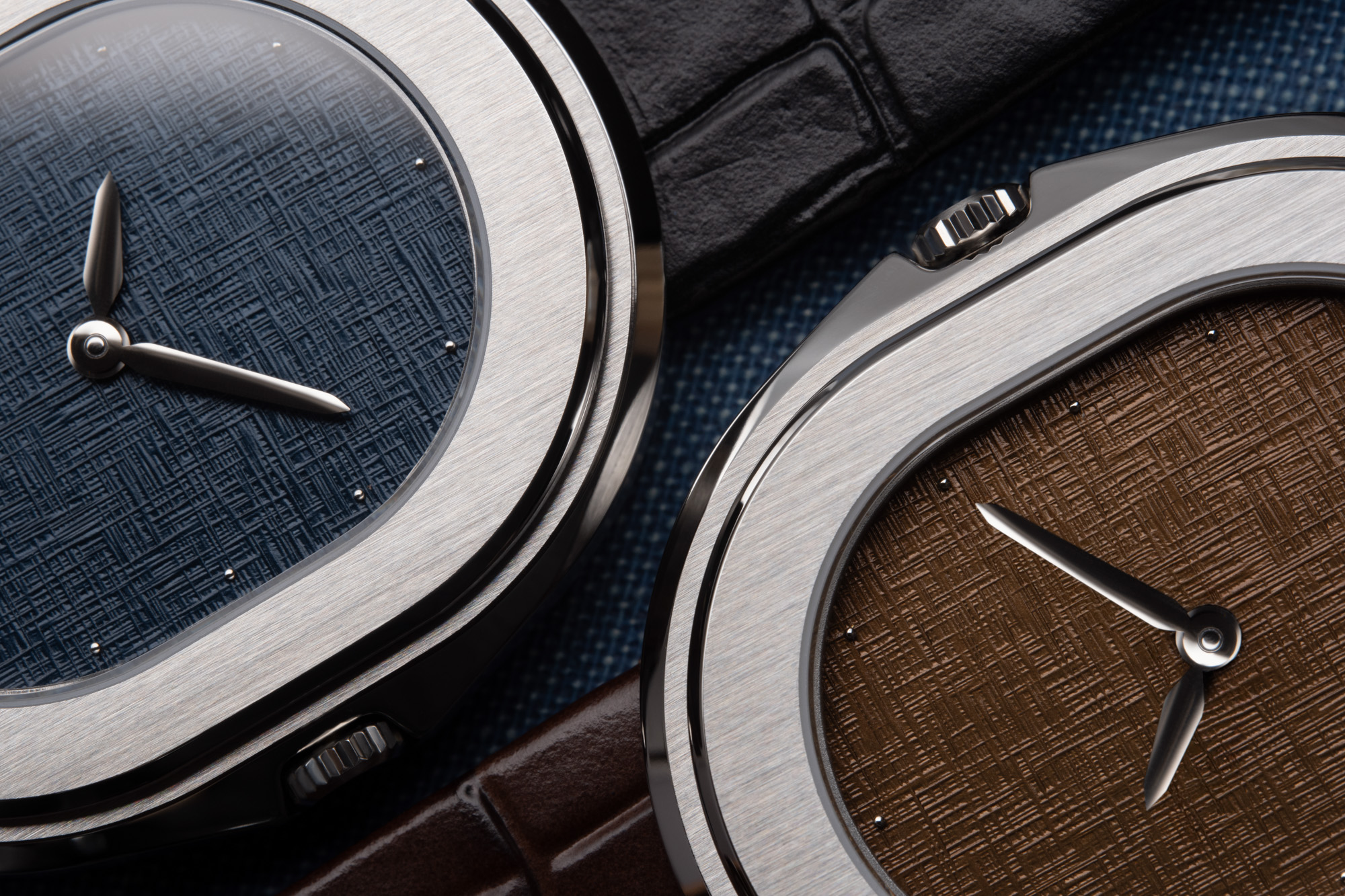 Upclose Side profile of 2 Serica 1174 Parade showing polished stainless steel case and crown detail