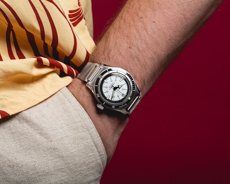 Serica 5303 white dial worn on mans wrist with his hand in his pocket